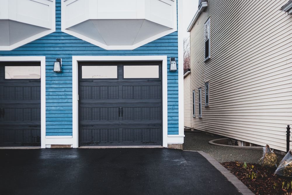 Asphalt driveway leading to a residential garage