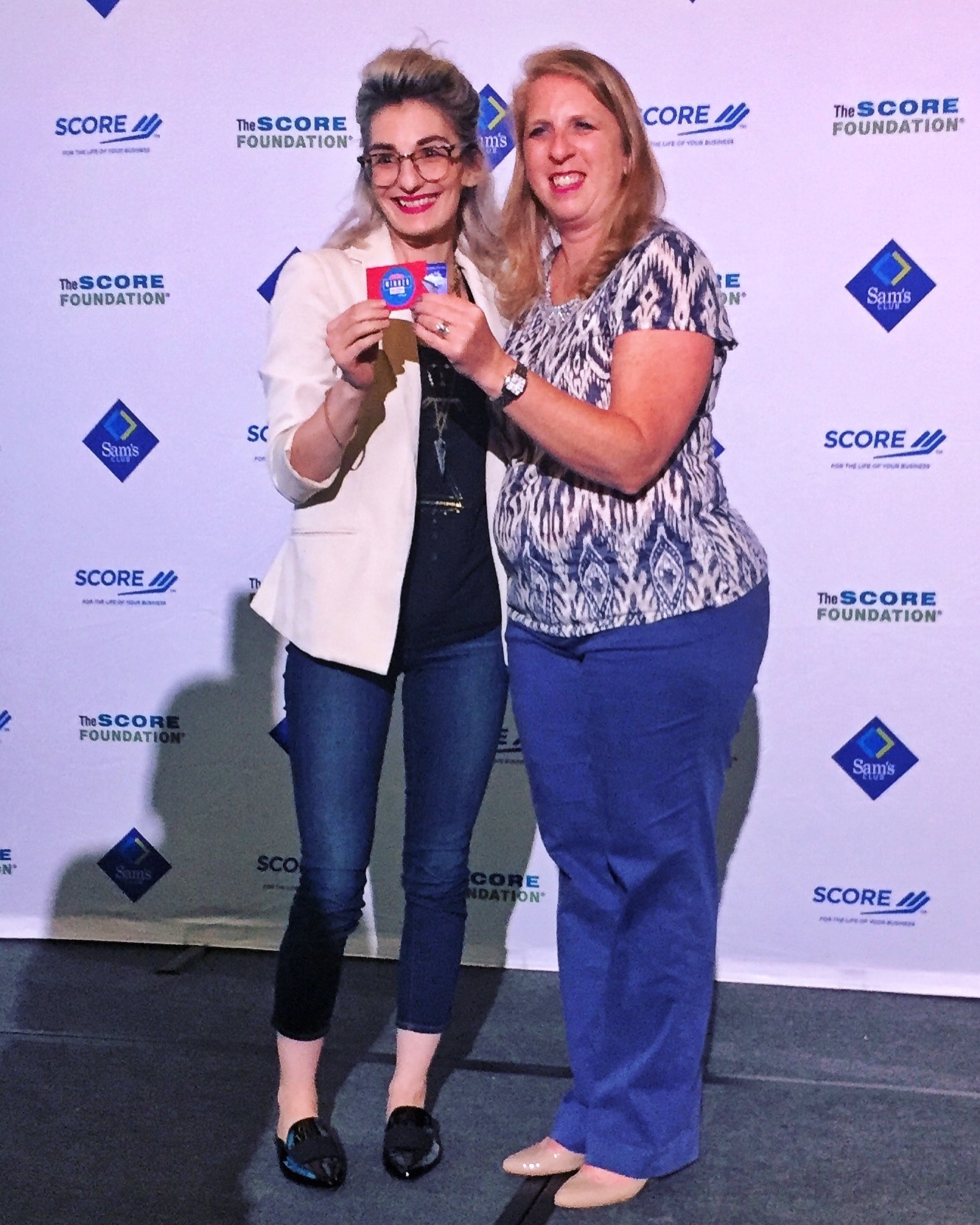 Kyira Hauer (left) accepts her SCORE award at the 2017 American Small Business Championship.