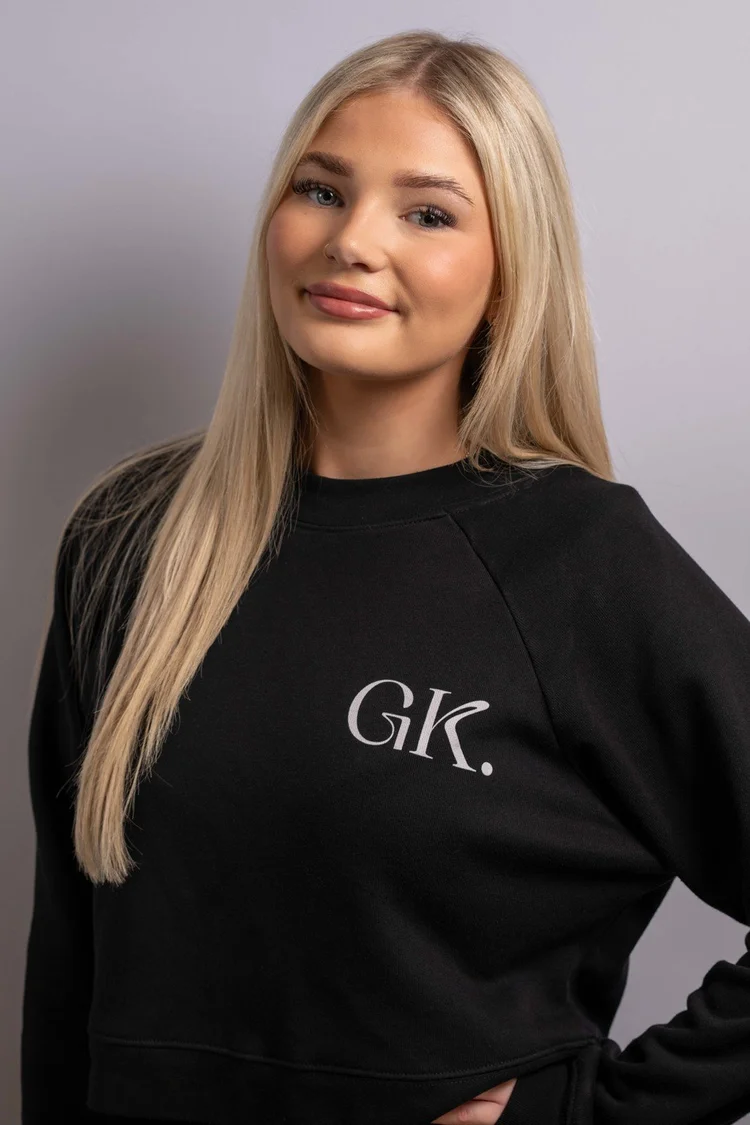 George Katsaros salon team portrait with long blonde hair and a black GK branded top