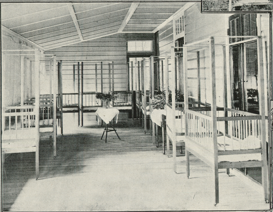 An interior view of Lynne Grove House in 1918, when it was the Corinda Infants' Home. This was one of the enclosed verandahs, used as a nursery.