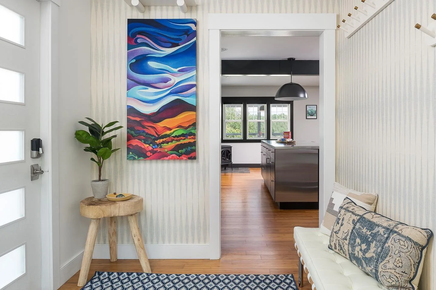 We love this shot of the entryway in the latest rental property we designed for @goodjujuvacationrentals 

The wallpaper and @laurelwatersart art really create a welcoming space. 

It also does a fantastic job of hiding the electrical box! 
📸: @ryan