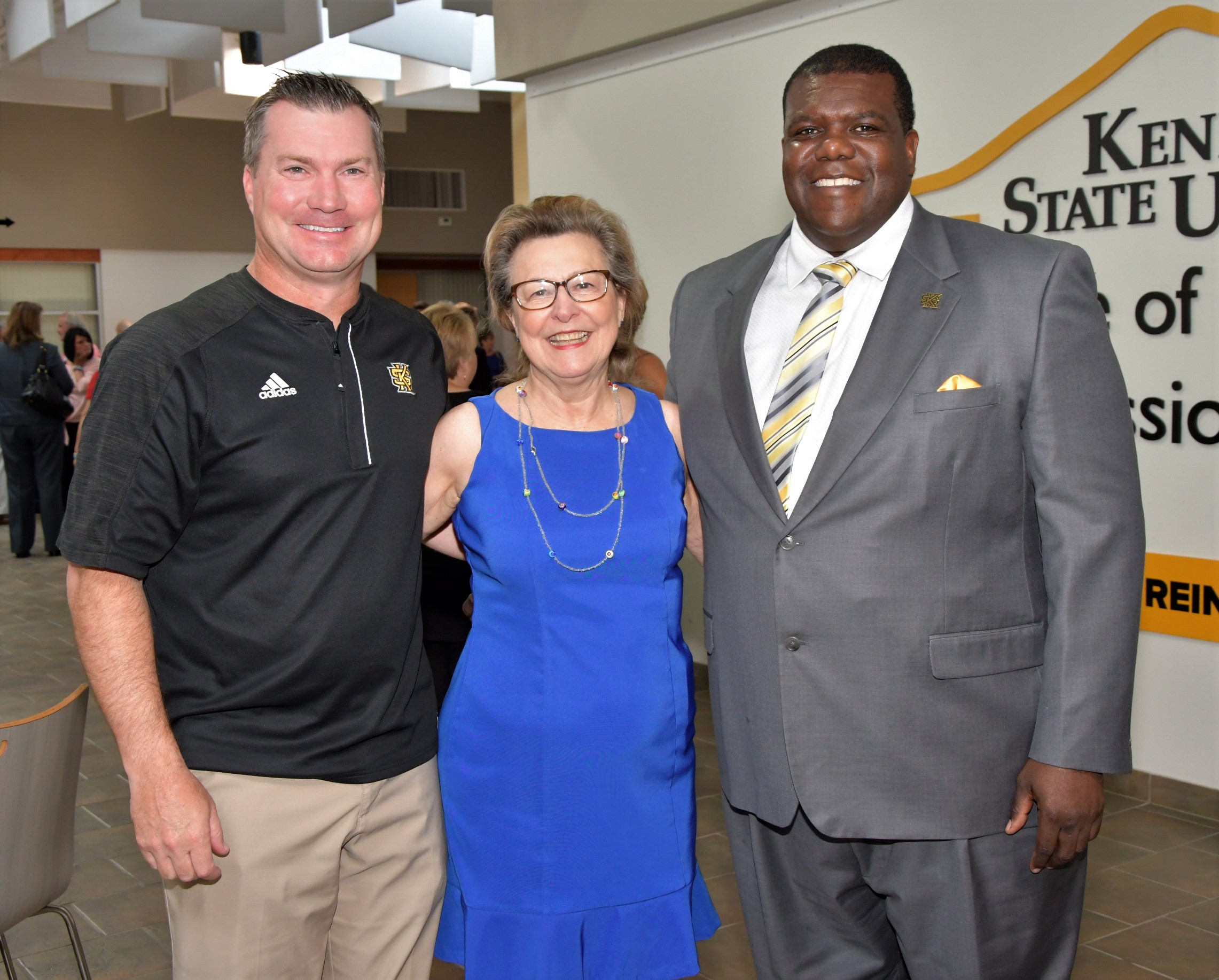 Shelley stands with Milton Overton, KSU Athletics Director, right, at the KBA Tuesday luncheon Aug. 14. Overton was the speaker for the month's event. At left is KSU Head Football Coach Brian Bohannon.