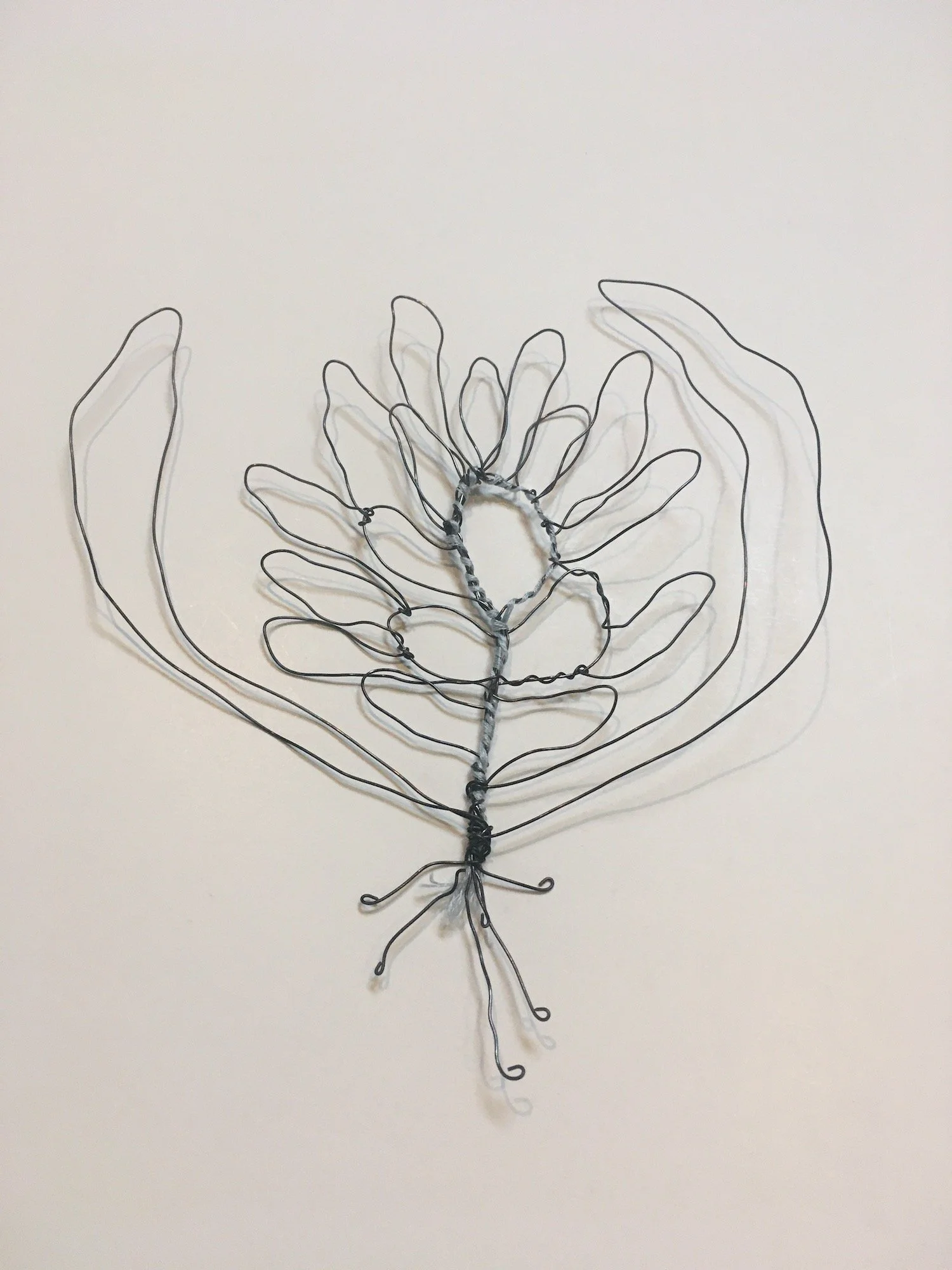 black wire, blue flower with leaves.JPG