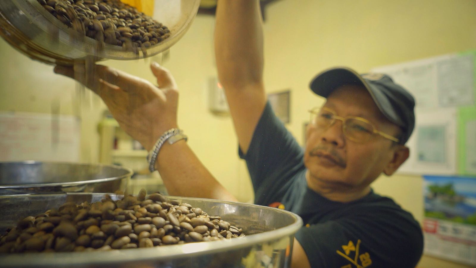 asep pouring beans into roaster.jpeg