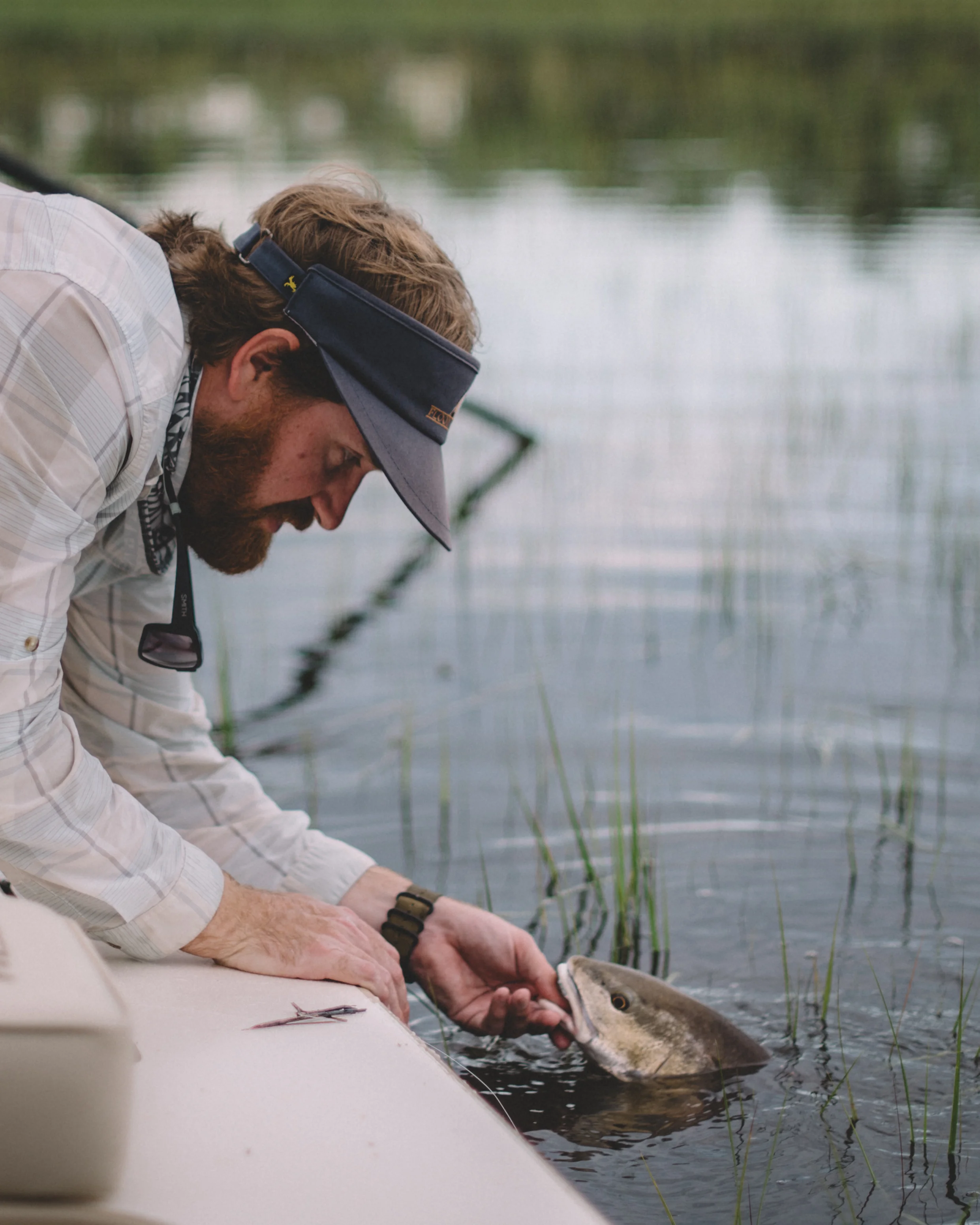 Capt Benton landing a flood tide redfish