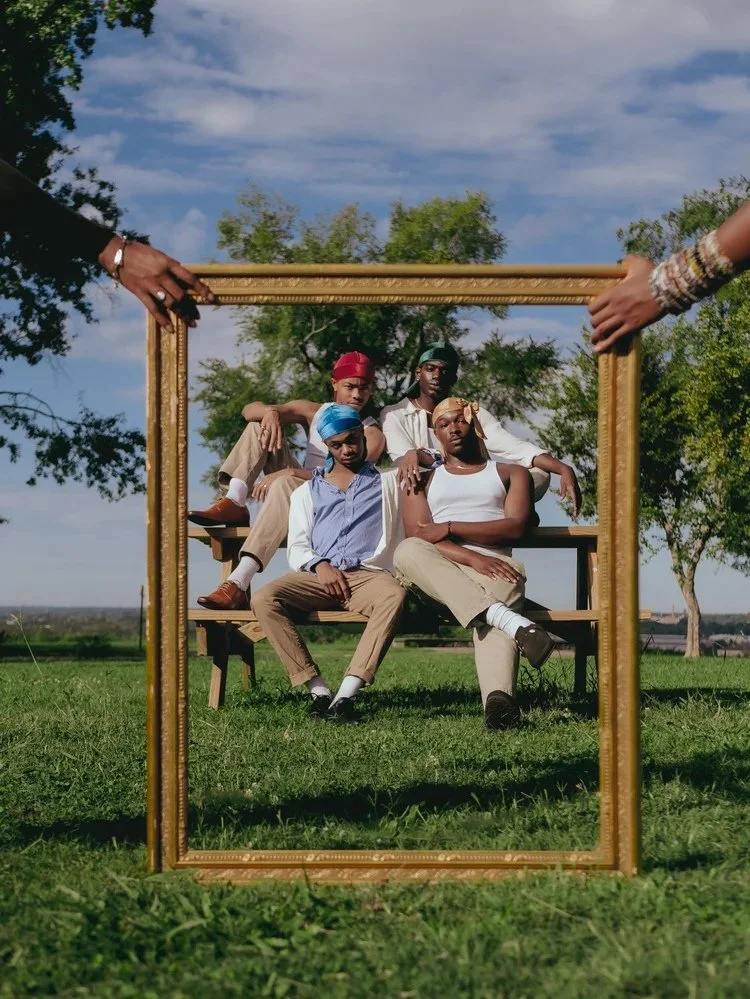 Friends seated outdoors appear inside a large gold picture frame in Durag Drag. Photography by Yonathan Mesfun.