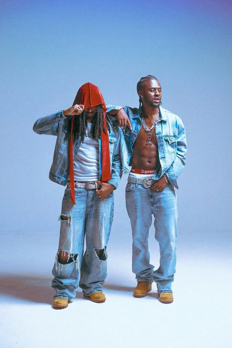 Two models in denim and a red durag pose against a blue backdrop in Denim Boyz. Photography by Yonathan Mesfun.