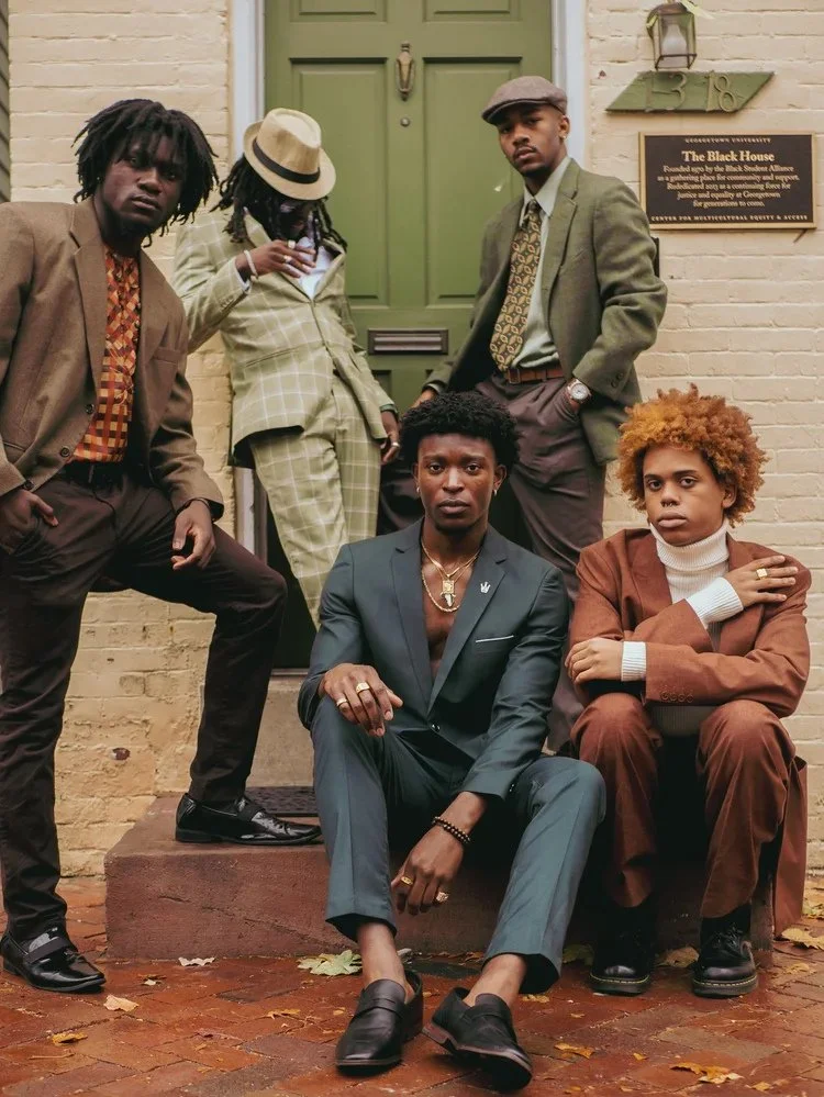 Models in colorful tailoring pose beside a green doorway in Gentlemen. Photography by Yonathan Mesfun.