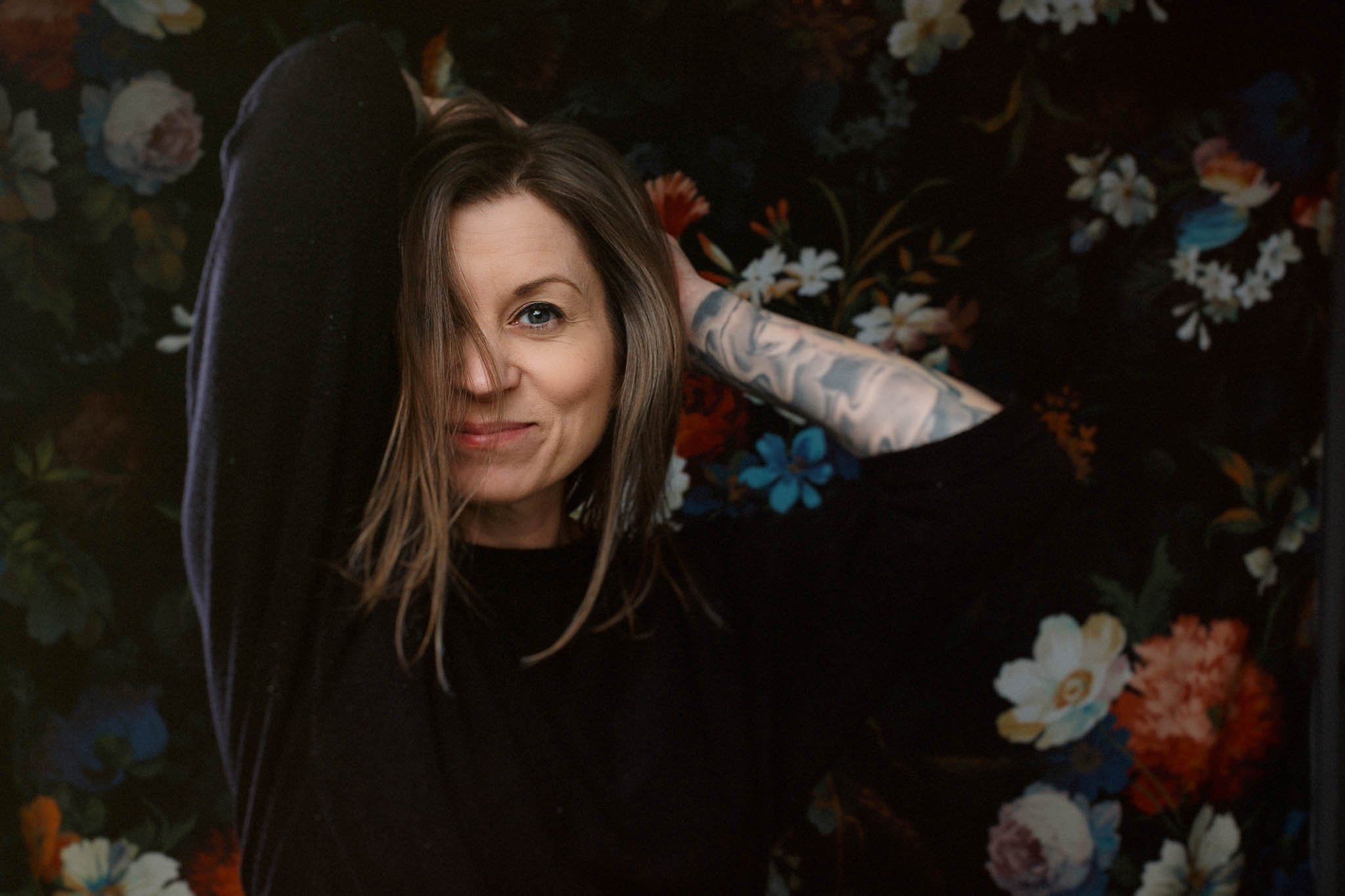 self portrait of photographer erin valkner black sweater blond hair dark floral background / Photo by Erin Valkner Photography of New Braunfels, Texas. See more at www.erinvalknerphotography.com/blog