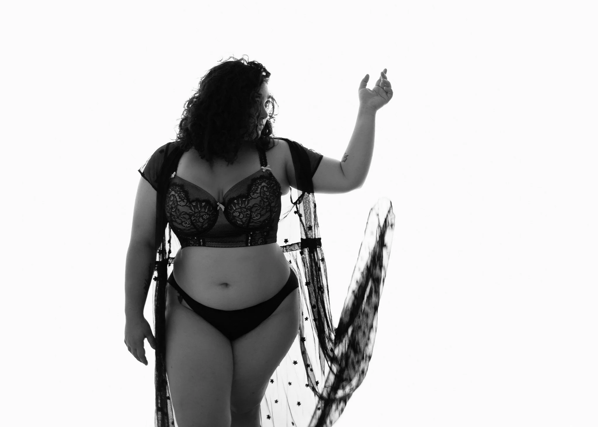 black and white boudoir portrait woman in lingerie and black lace robe new braunfels boudoir photographer / Photo by Erin Valkner Photography of New Braunfels, Texas. See more at www.erinvalknerphotography.com/blog