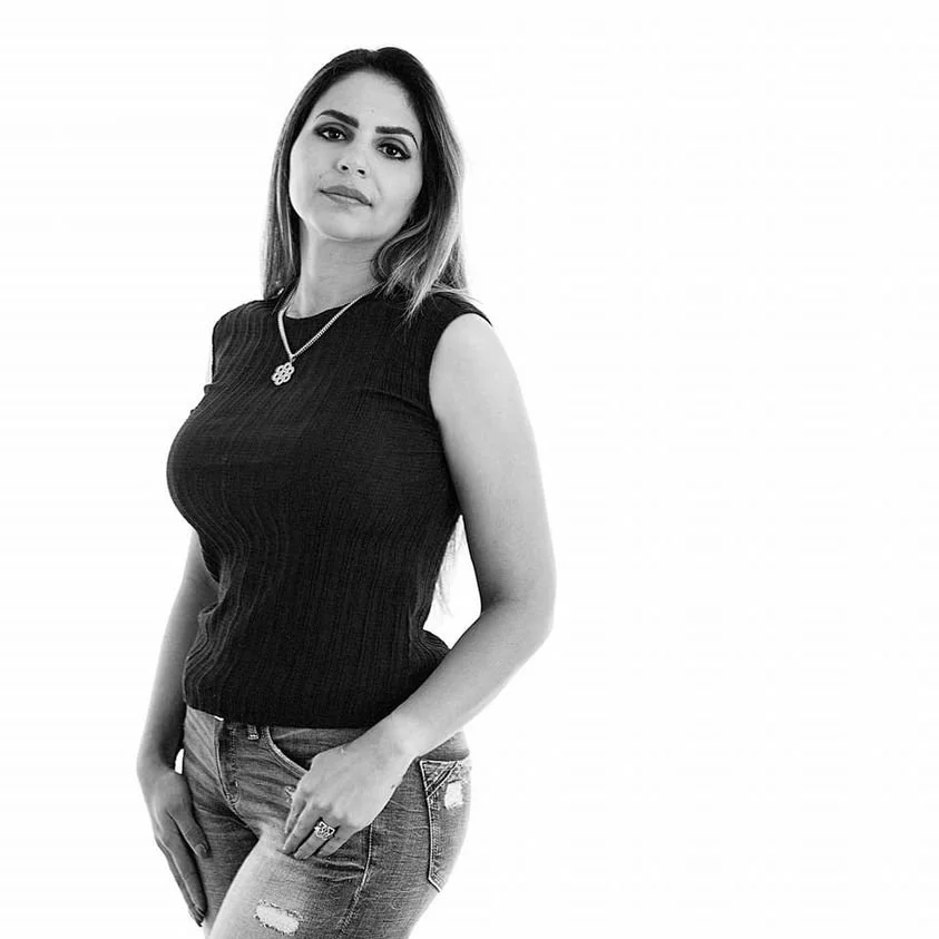 black and white portrait of woman with confident expression white background / Photo by Erin Valkner Photography of New Braunfels, Texas. See more at www.erinvalknerphotography.com/blog