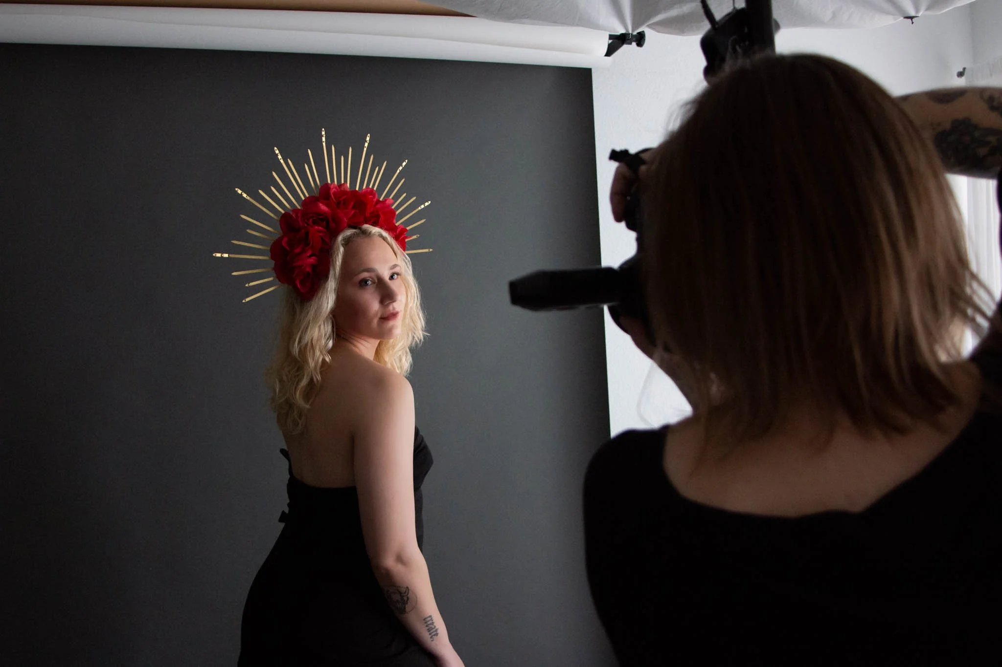 behind the scenes photographer with camera and woman in black dress and flower crown in new braunfels texas studio / Photo by Erin Valkner Photography of New Braunfels, Texas. See more at www.erinvalknerphotography.com/blog