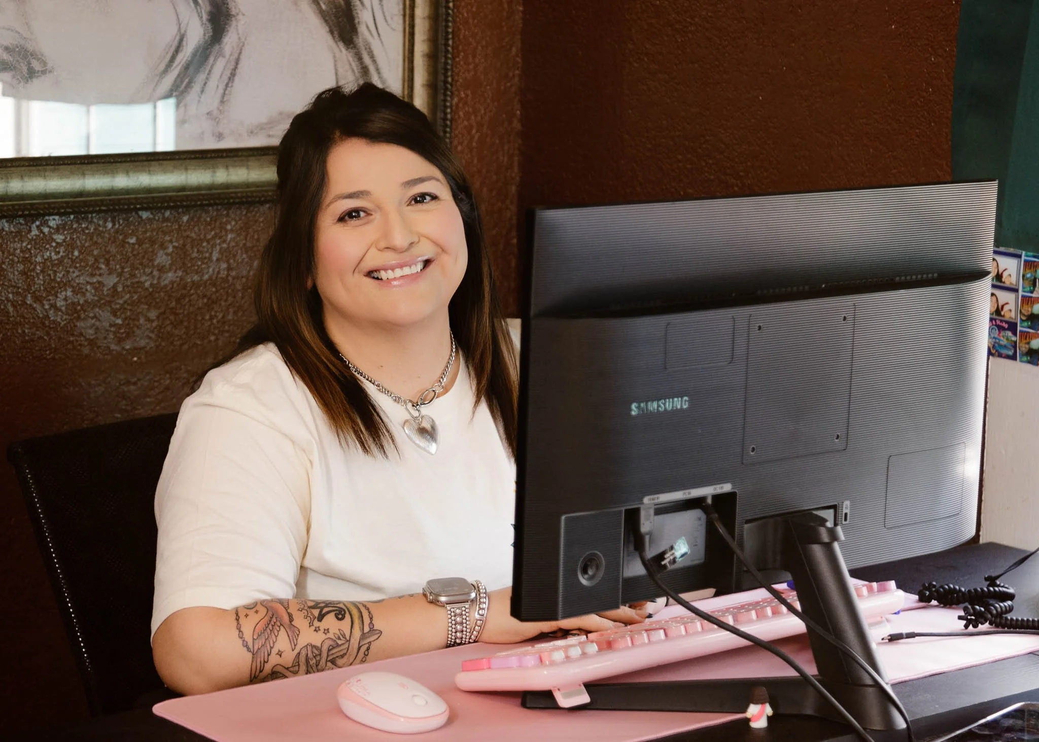 behind the scenes photo of Free Me Bail Bonds owner Nicole Guerra working at computer sitting at desk / Photo by Erin Valkner Photography of New Braunfels, Texas. See more at www.erinvalknerphotography.com/blog