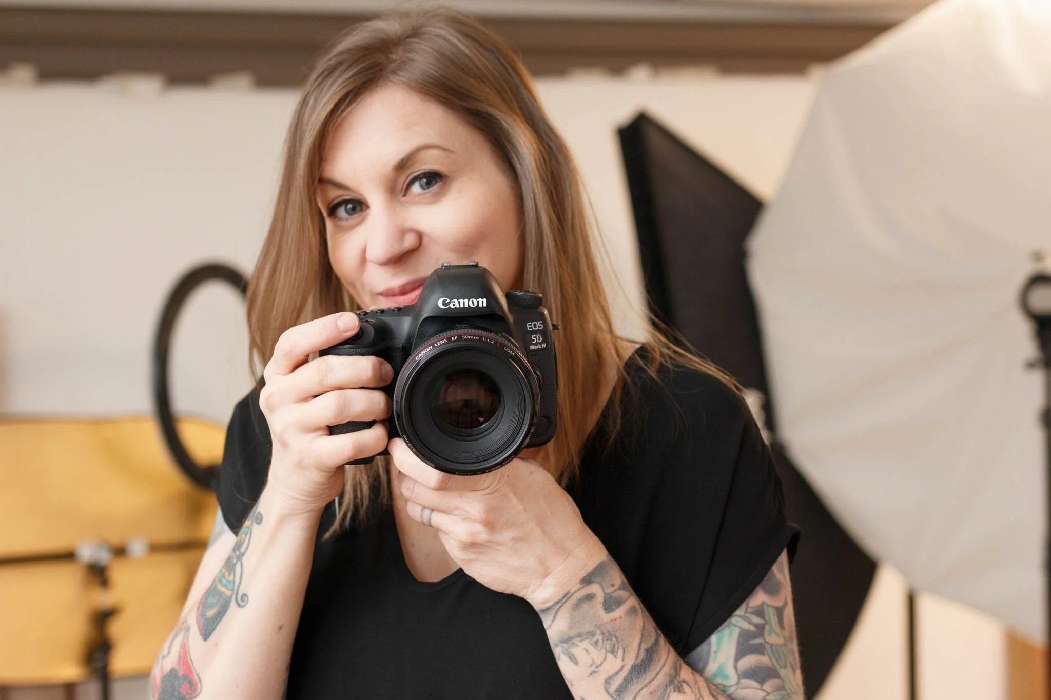 photographer with camera in studio / Photo by Erin Valkner Photography of New Braunfels, Texas. See more at www.erinvalknerphotography.com/blog