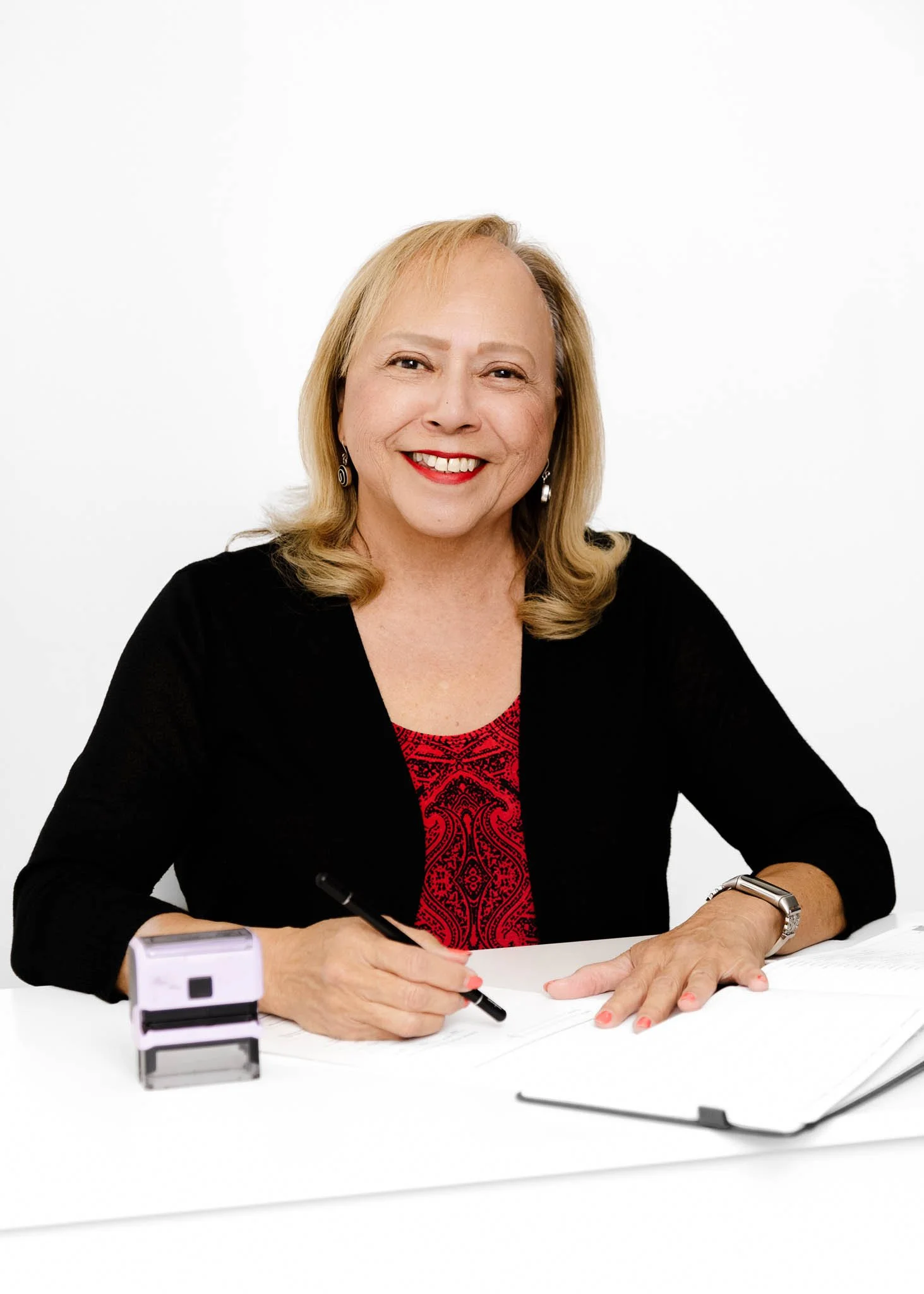 branding photo of mobile notary, woman sitting at desk with notary book and stamp white background / Photo by Erin Valkner Photography of New Braunfels, Texas. See more at www.erinvalknerphotography.com/blog
