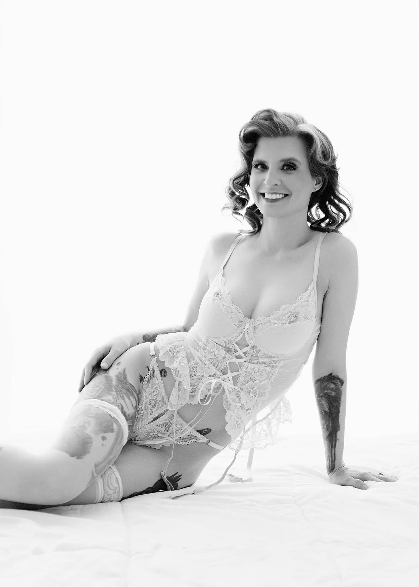 black and whtie boudoir photo of woman sitting backlight background in studio | see more at erinvalknerphotography.com/blog