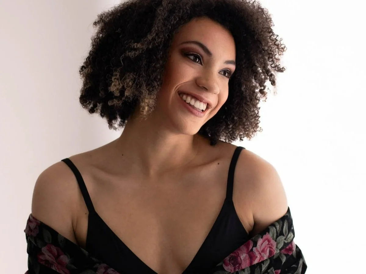 portrait of woman smiling looking away white backgound in studio new braunfels texas / Photo by Erin Valkner Photography of New Braunfels, Texas. See more at www.erinvalknerphotography.com/blog