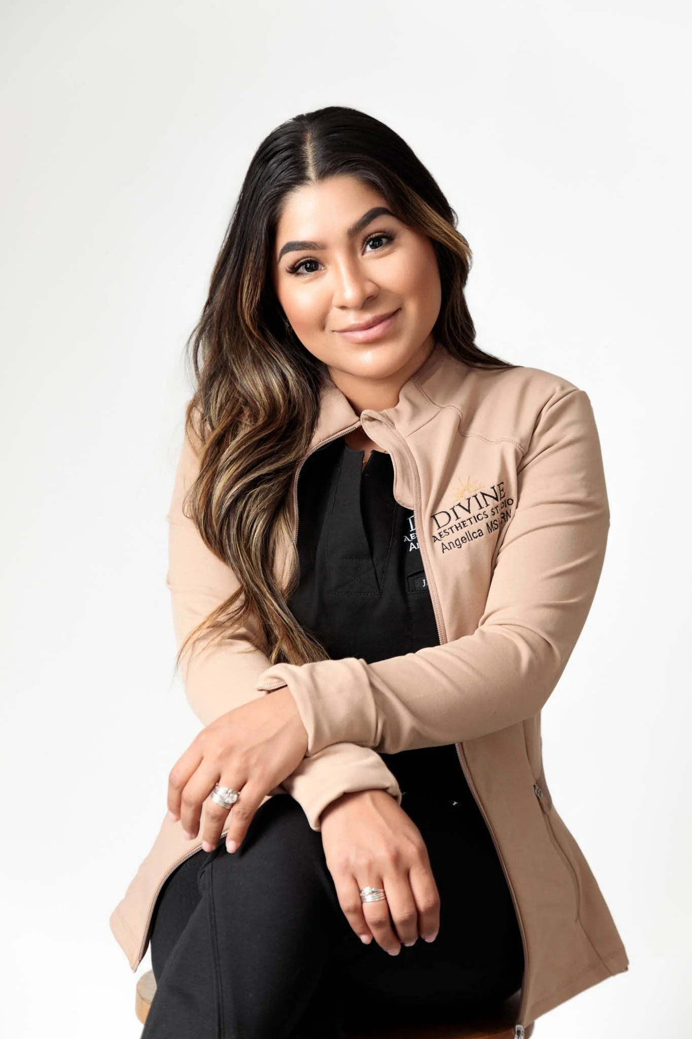 esthetician branding photo smiling woman seated on stool white background new braunfels texas / Photo by Erin Valkner Photography of New Braunfels, Texas. See more at www.erinvalknerphotography.com/blog