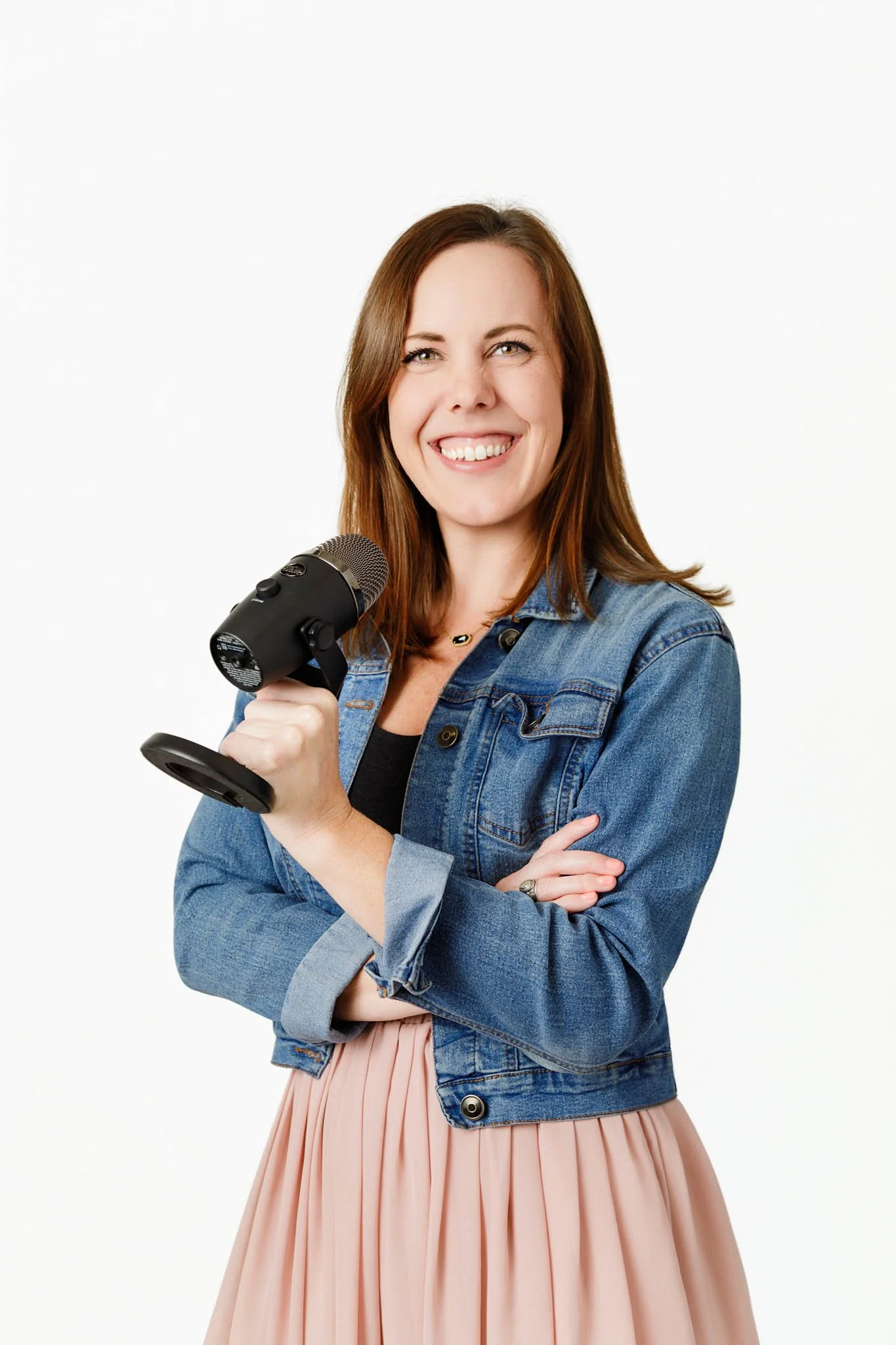 branding photo female podcast host holding microphone white background / Photo by Erin Valkner Photography of New Braunfels, Texas. See more at www.erinvalknerphotography.com/blog