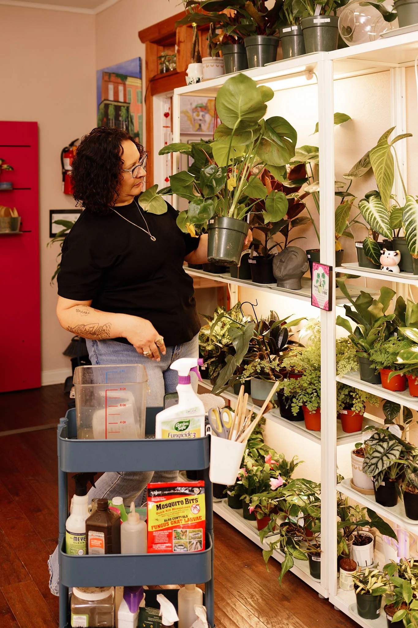 behind the scenes photo of owner of Plant Culture Potting Bar tending to plants in the store / Photo by Erin Valkner Photography of New Braunfels, Texas. See more at www.erinvalknerphotography.com/blog