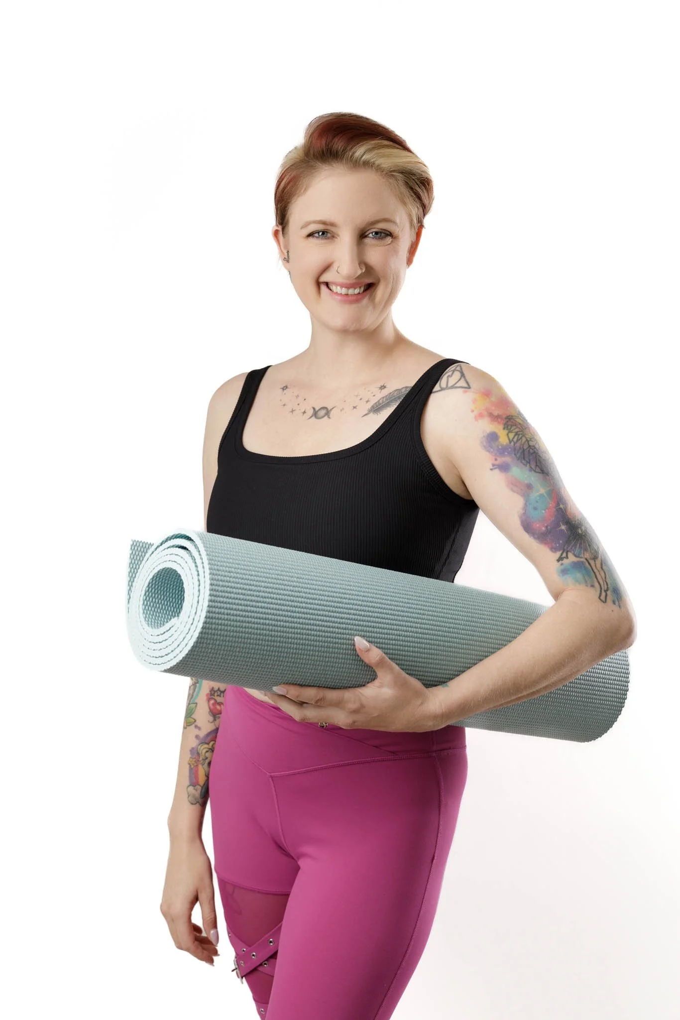 branding photo of woman with tattoos and short blond hair holding rolled yoga mat wearing black workout top and hot pink leggings yoga pants / Photo by Erin Valkner Photography of New Braunfels, Texas. See more at www.erinvalknerphotography.com/blog