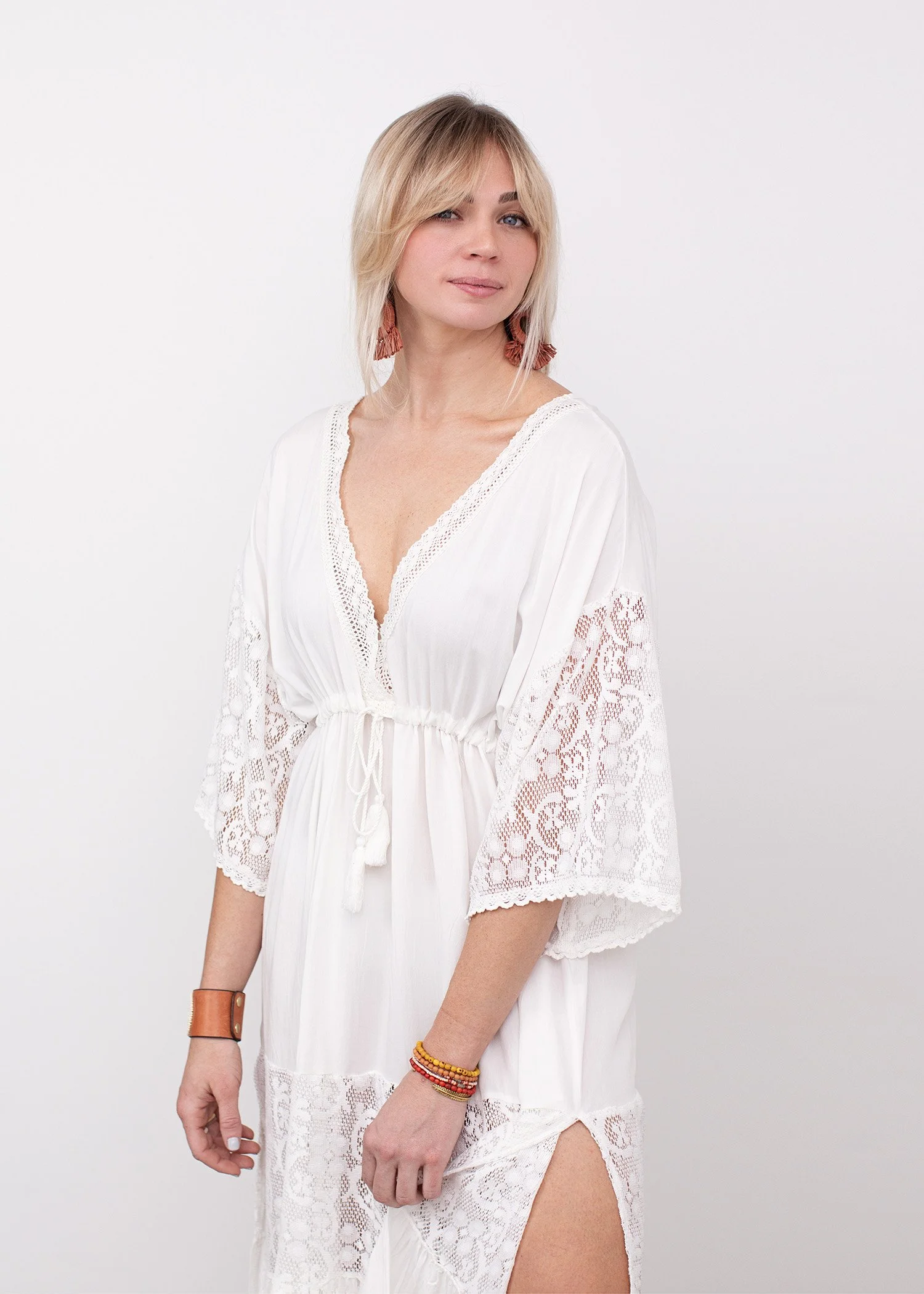 portrait of woman wearing white dress with white backgound in new braunfels texas studio Photo by Erin Valkner Photography of New Braunfels, Texas. See more at www.erinvalknerphotography.com/blog