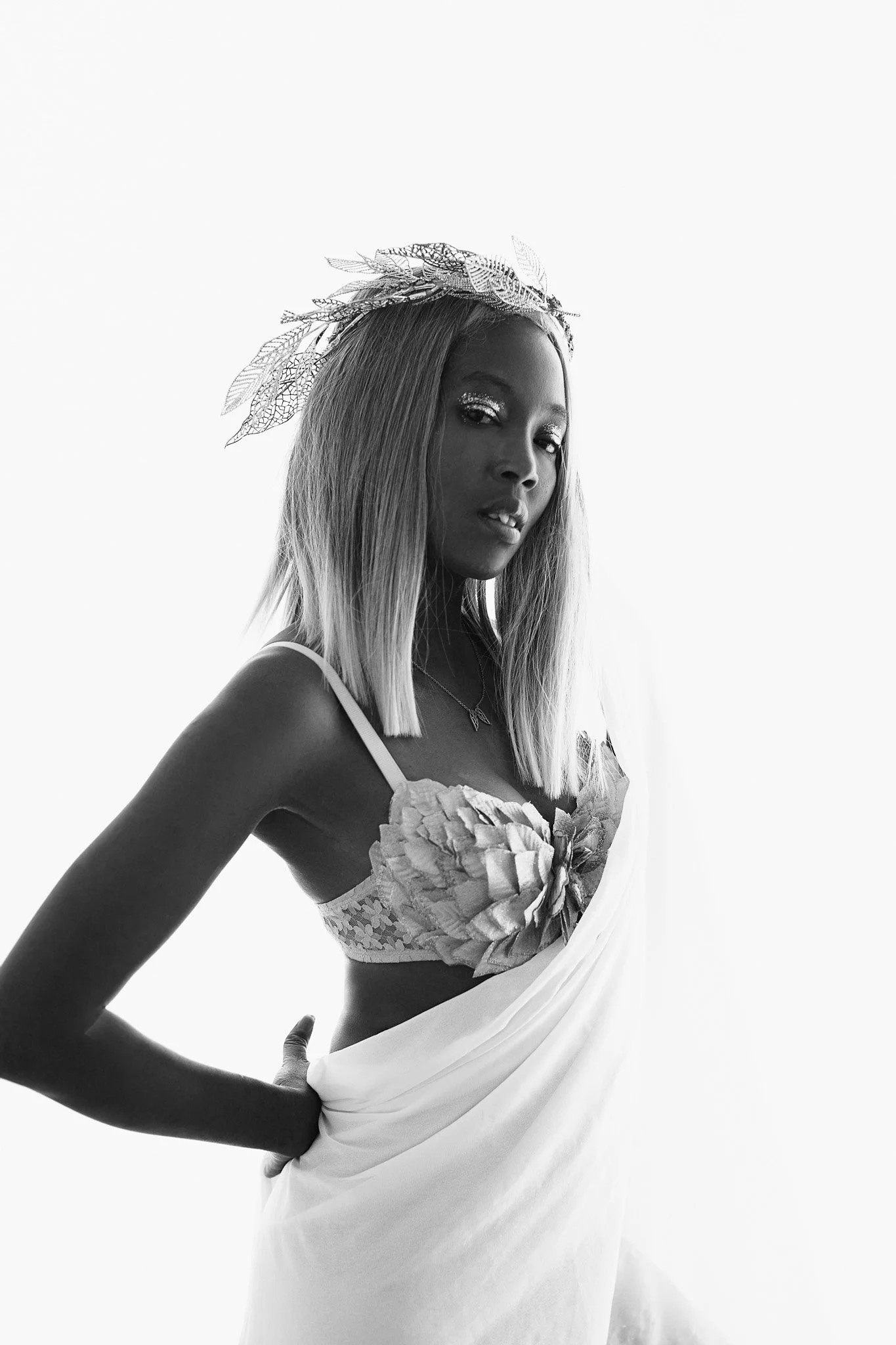 woman with decorative bra and chiffon fabric wearing goldleaf crown and eyeshadow dark skin light hair / Photo by Erin Valkner Photography of New Braunfels, Texas. See more at www.erinvalknerphotography.com/blog