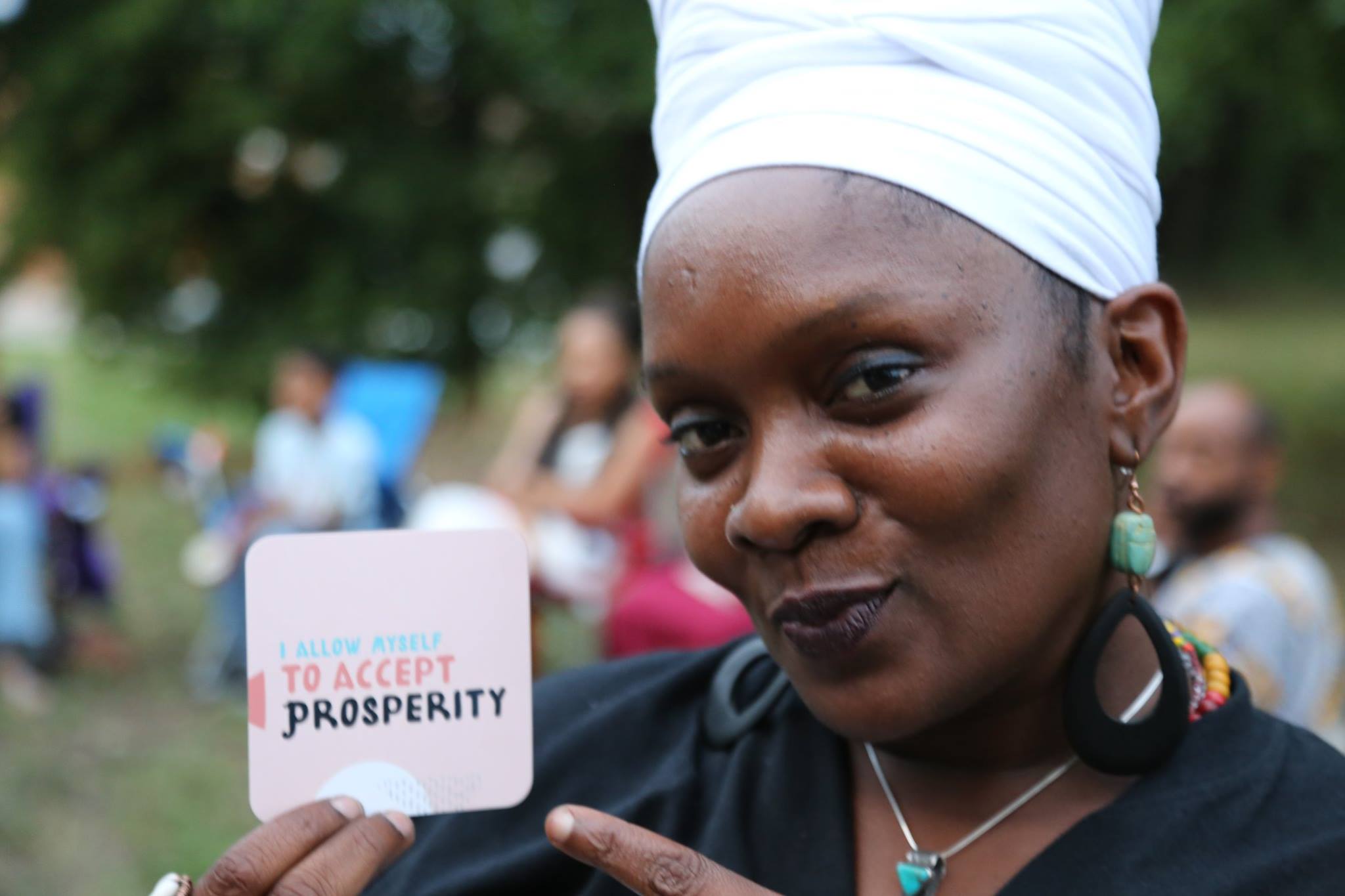 Healer holding up affirmation card. 