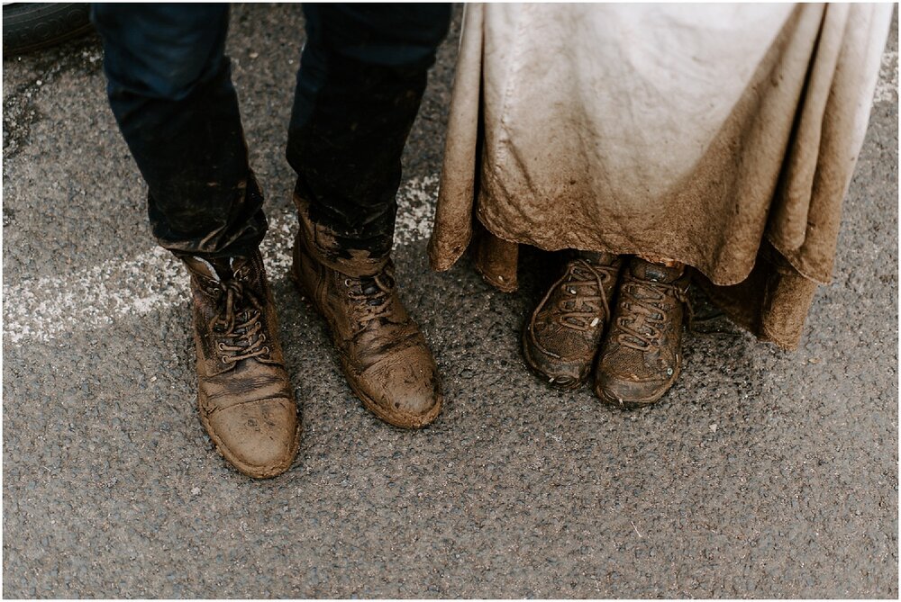 newlyweds showing off their dirty boots and dress during their trash the dress hawaii session. 