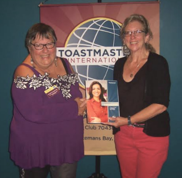 Barbara (right) is presented with her first Toastmasters manual by VP Membership Amanda Annabel