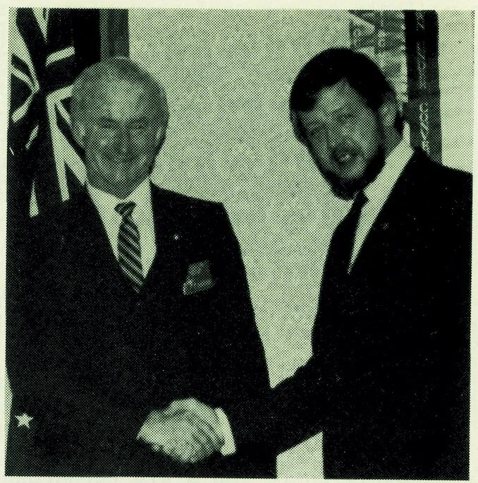 Ken Rennie DTM being congratulated by District Governor Geoff Kirkwood