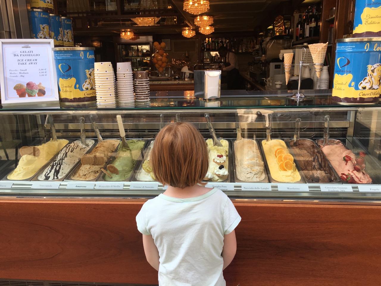 My daughter, contemplating gelato in Milan.