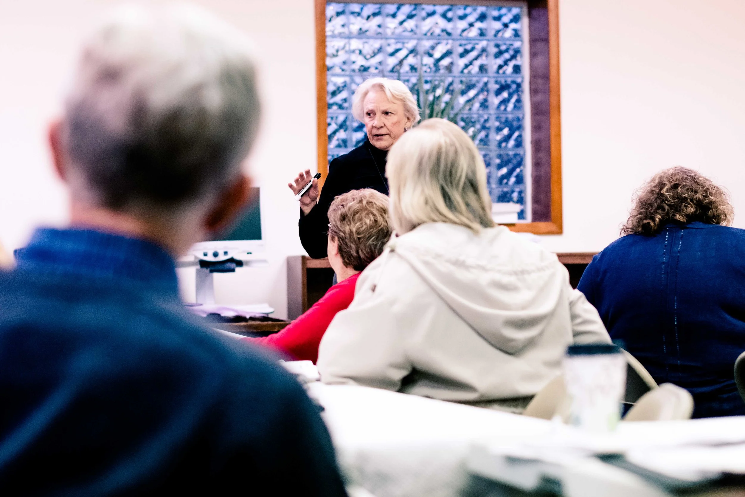 Gretchen Esping leads the Monday night class in a conversation.