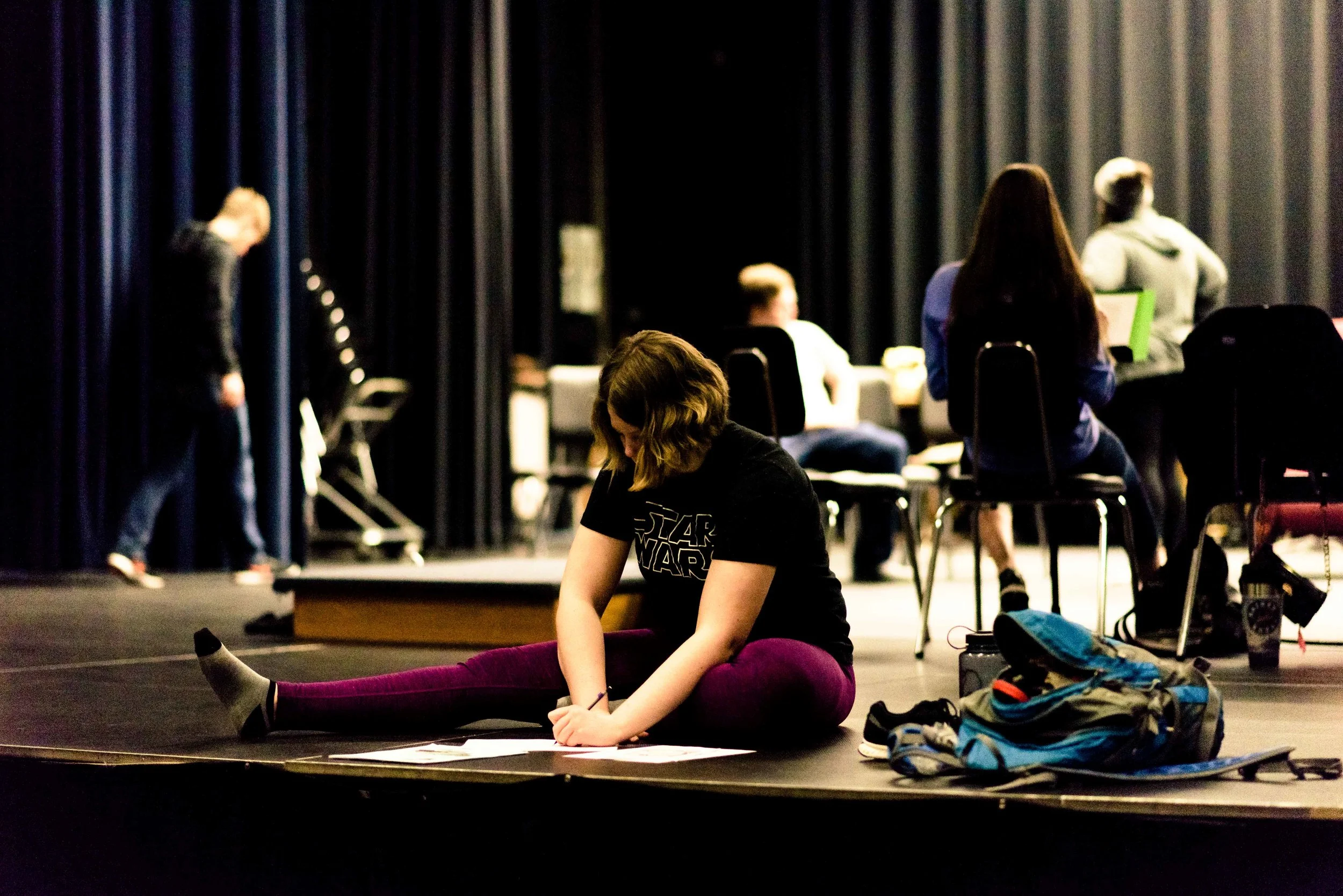 Elise Nelson makes some notes in her script during a scene change.
