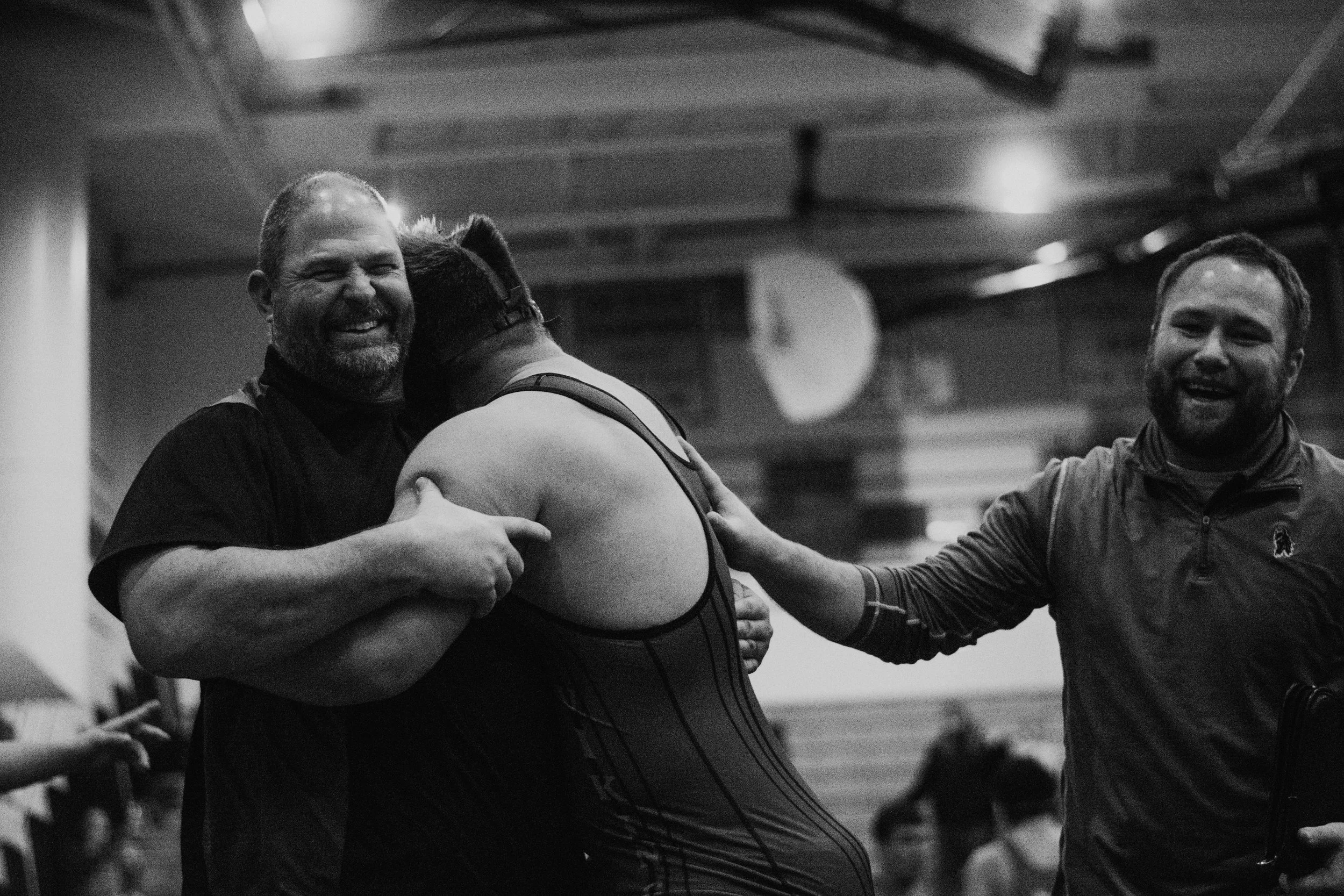 Victory hugs for Wampler from Coach Ben Elliot and Assistant Coach Adam Lackey
