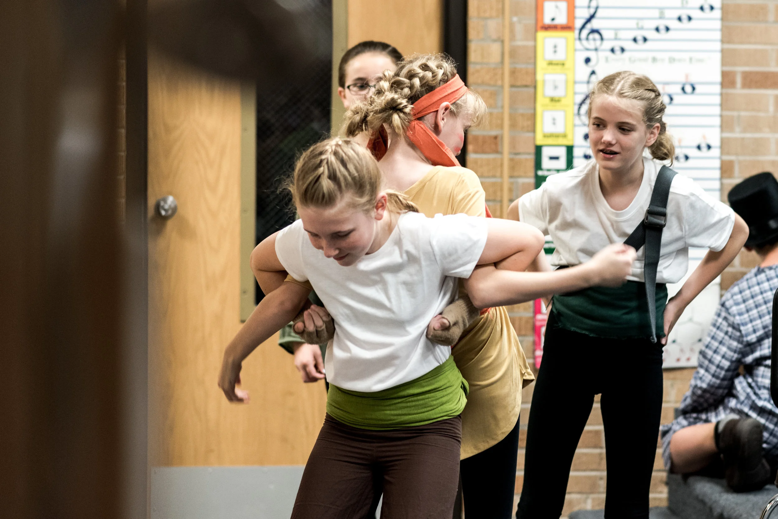 Erin Dolezal (foreground) and sisters - Esther and Echo Clark tighten up a tricky dance move before the curtain goes up.