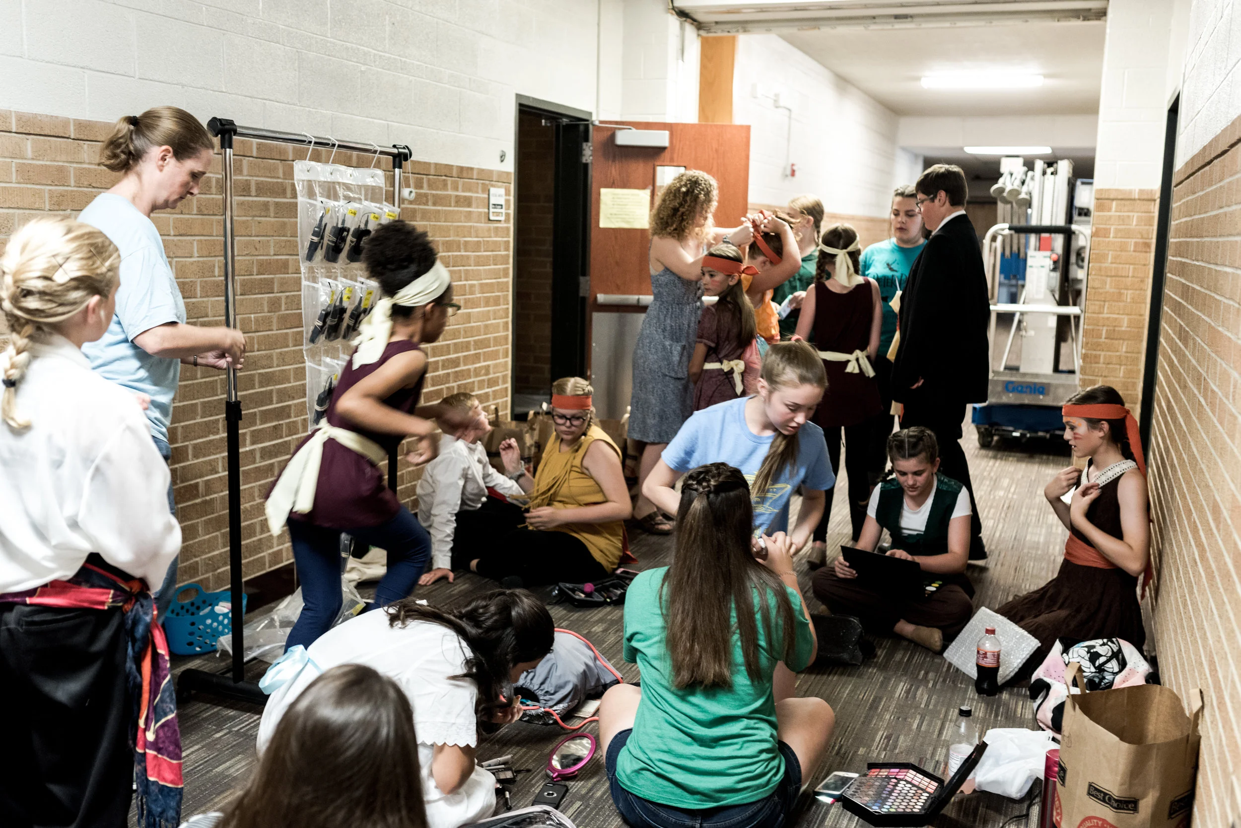 Last minute touches and encouragement as the cast prepares to shine.