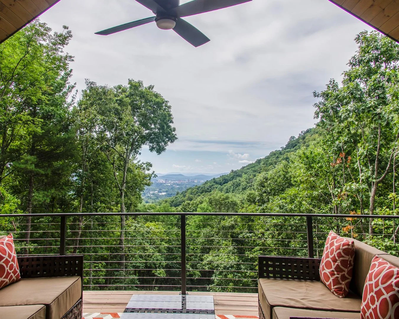 Spring brings the perfect weather to start enjoying the beautiful Asheville views again, like this one of stunning downtown!⁠
⁠
This back deck spans nearly the entire width of the home, with minimally obscuring stainless steel cable railing.⁠
⁠
Call 