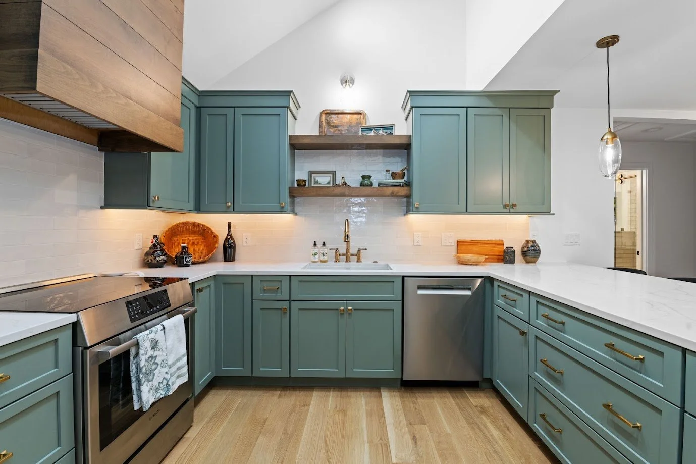 Sage green Starmark shaker cabinets with gold hardware, white quartz countertops, and glazed white tile backsplash — Asheville NC kitchen remodel