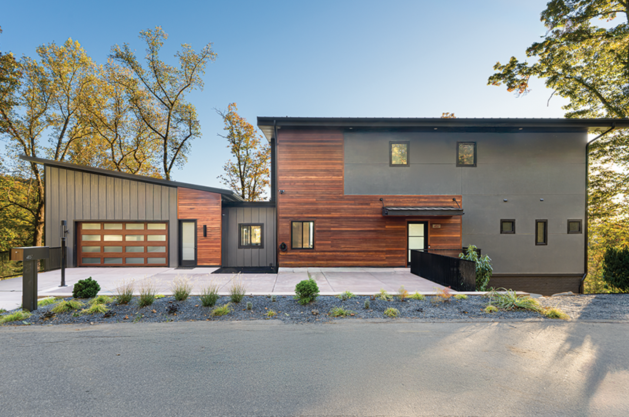 Modern exterior of a mountainside home addition in Asheville NC with fall landscaping