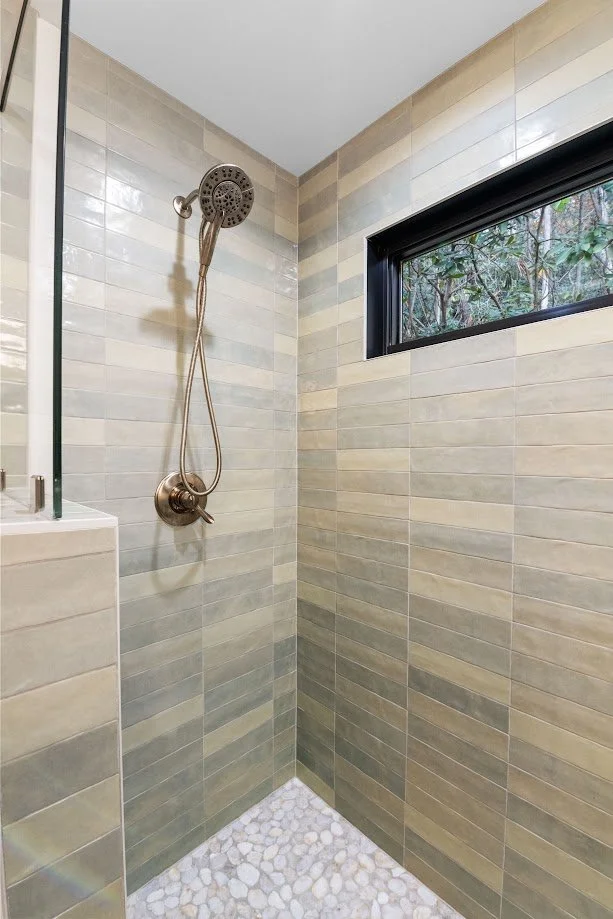 asheville-primary-bath-shower-tile-glazed-green-pebble-floor-homesource-design-center.jpg