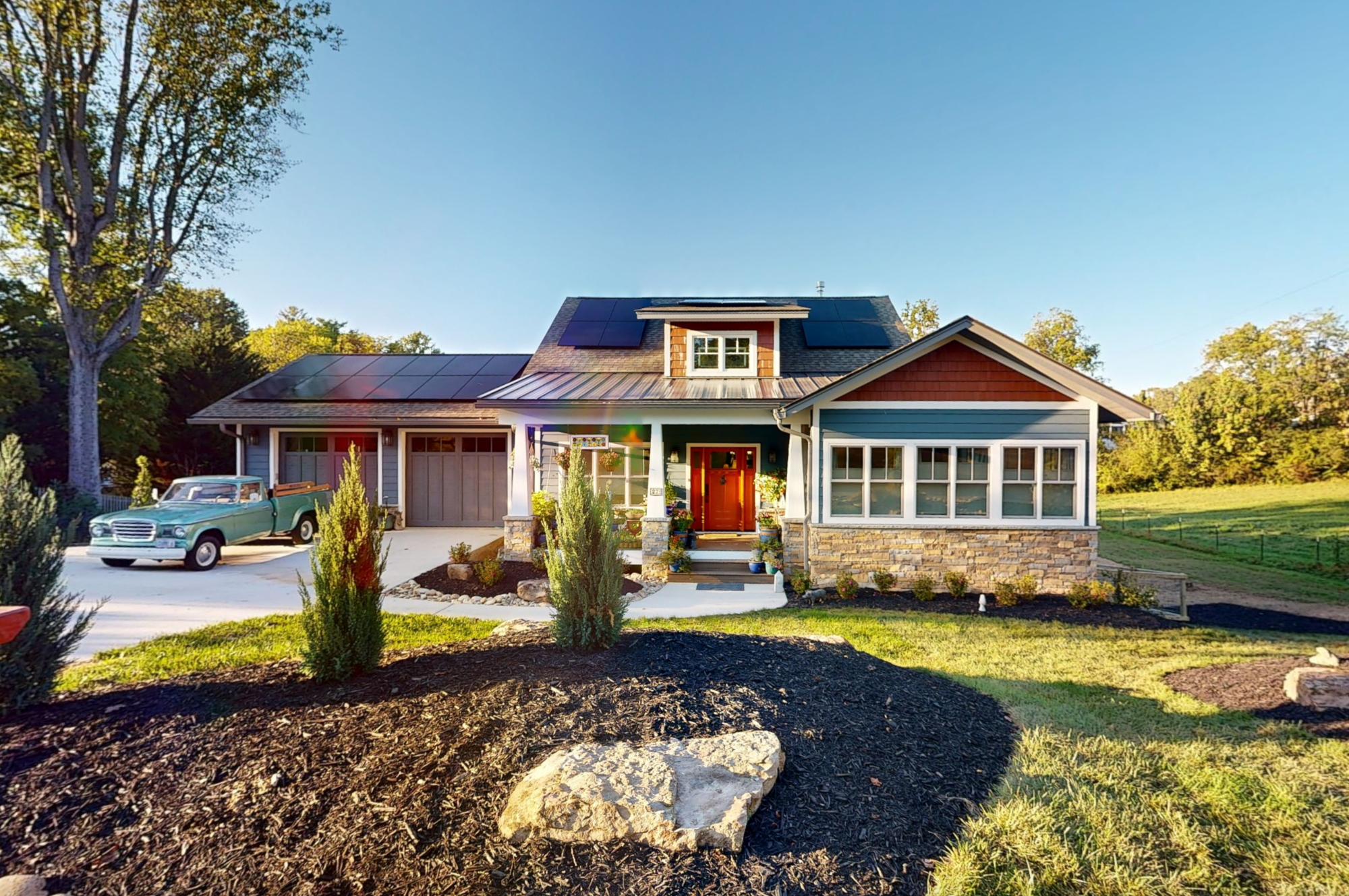 Award-winning craftsman home in Weaverville NC featuring solar panels, stone accents, and sunroom windows