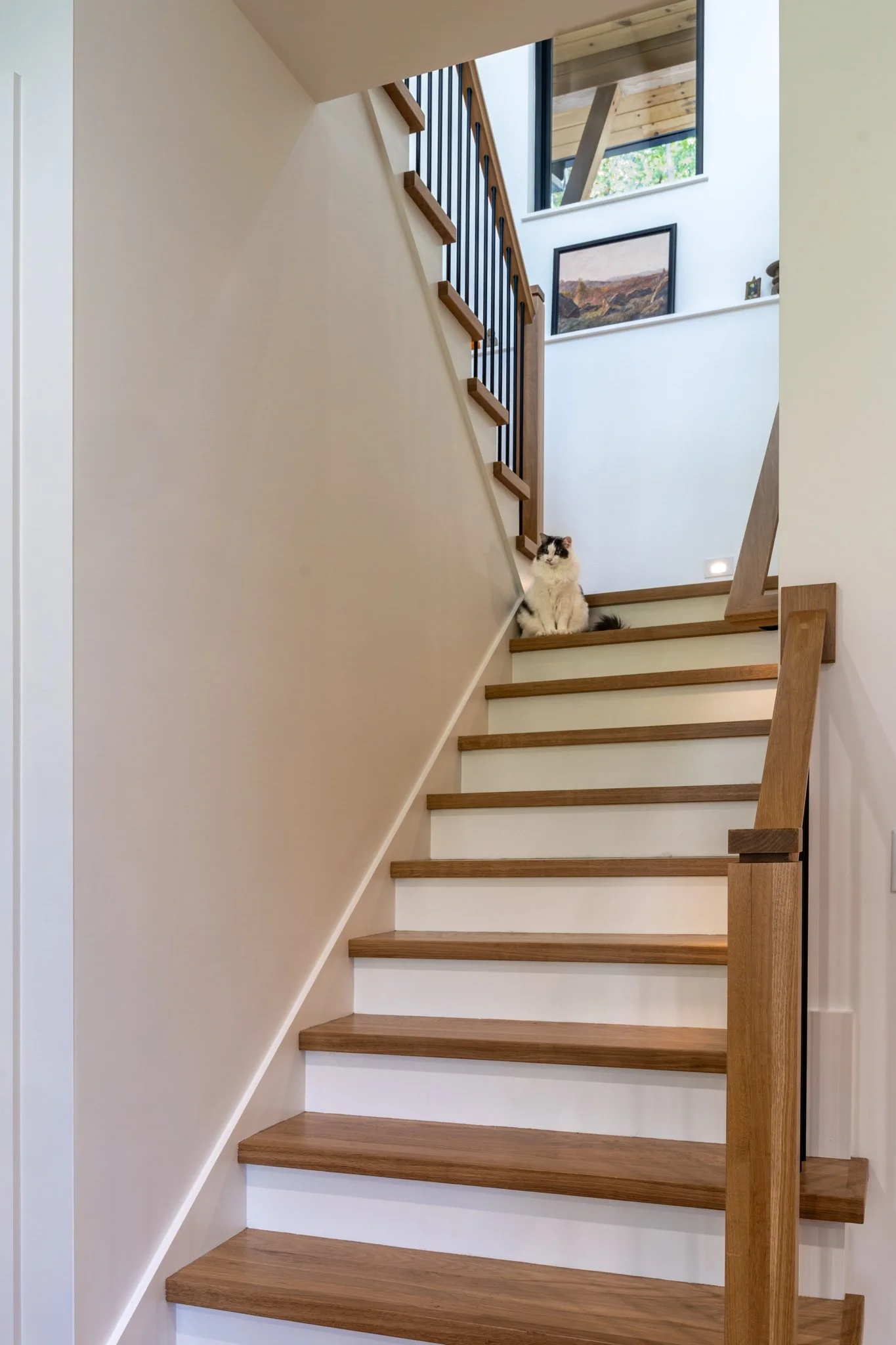 homesource-custom-home-staircase-white-oak-treads-black-balusters.jpg