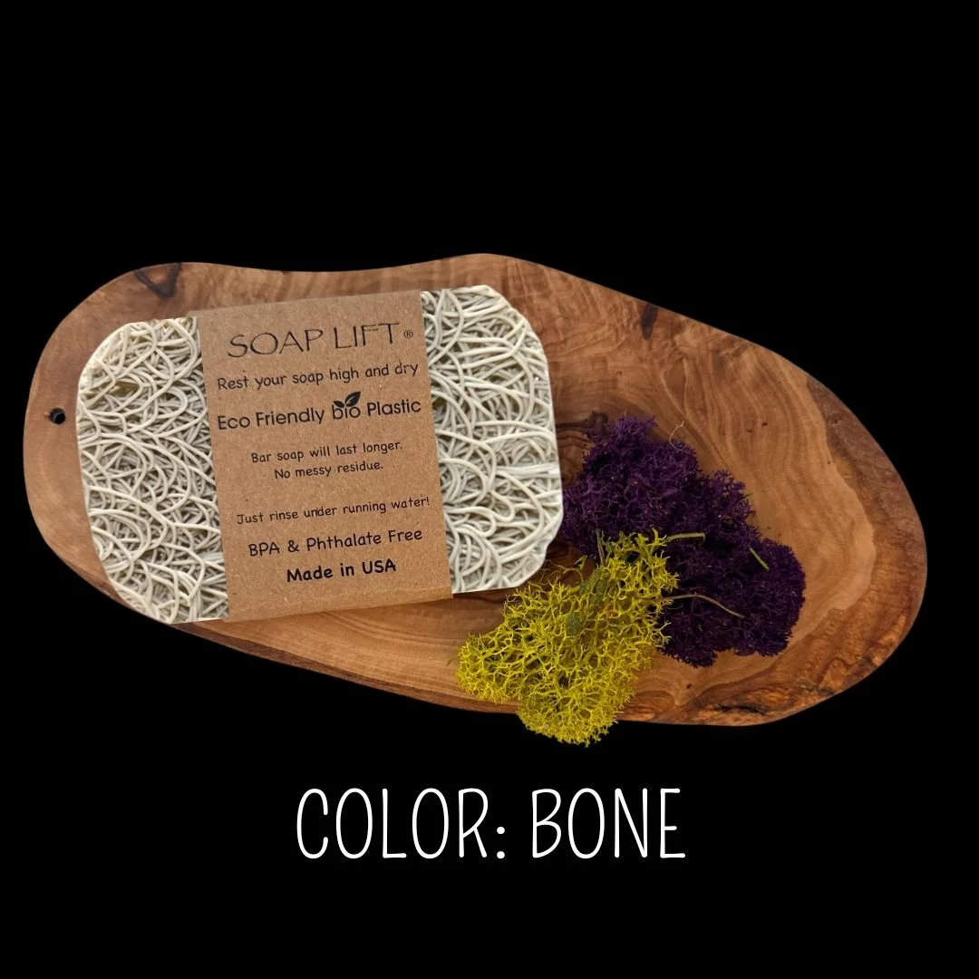 Bone Soap Lift eco-friendly bio plastic soap dish on a dark rustic wood surface