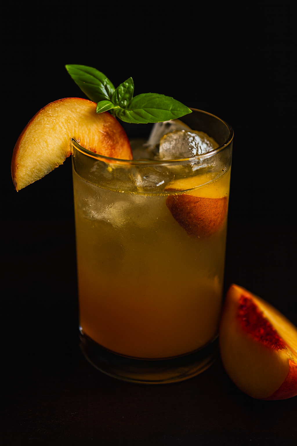 Summer peach balsamic fizz — golden peach cocktail on the rocks with fresh peach and mint garnish, The Tea Tree