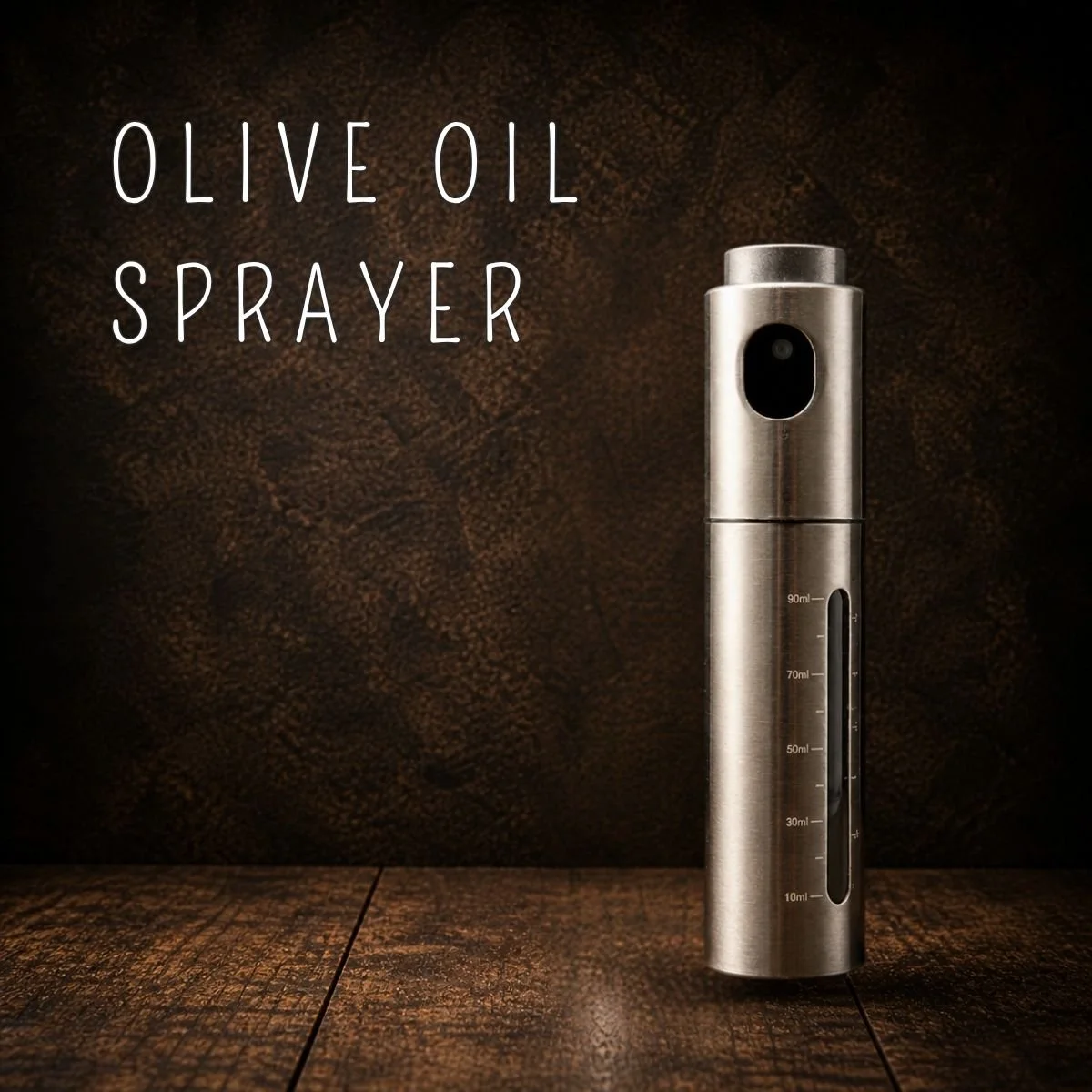 Stainless steel olive oil sprayer mister with measurement markings, 3 oz capacity, on a dark wood surface