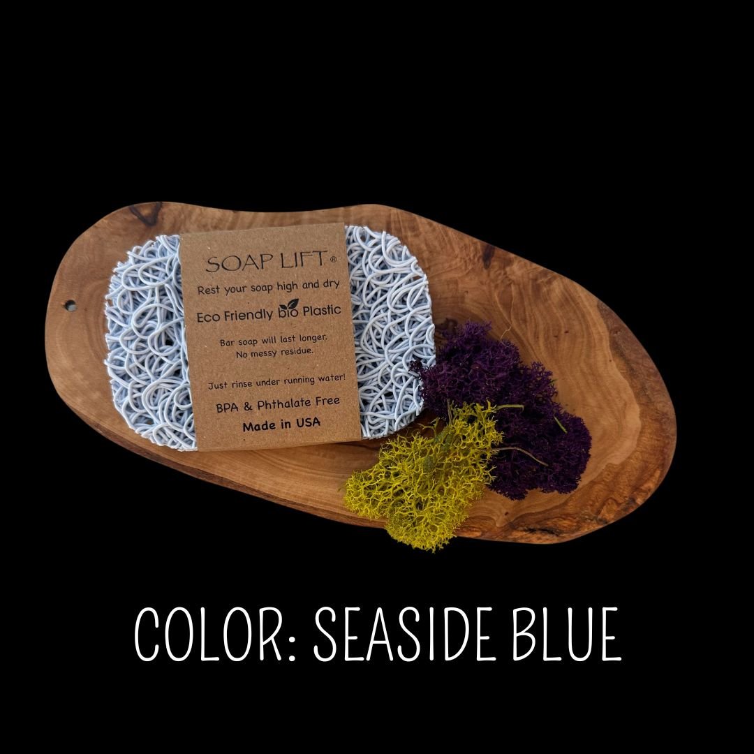 Seaside blue Soap Lift eco-friendly bio plastic soap dish on a dark rustic wood surface