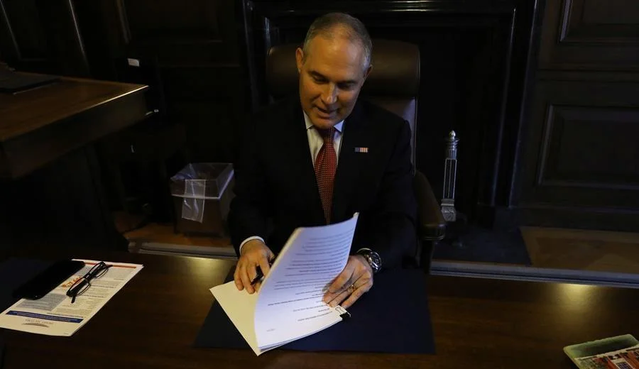 EPA Administrator Scott Pruitt signs the paperwork to revoke the Clean Power Plan. Photo: EPA 