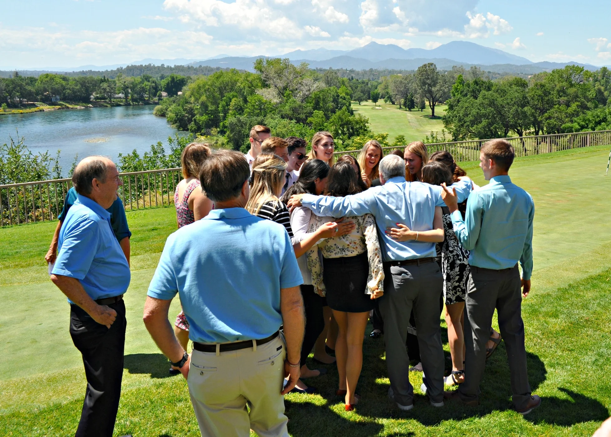 President Lon McCasland gives this year Scholarship Recipients a group hug.