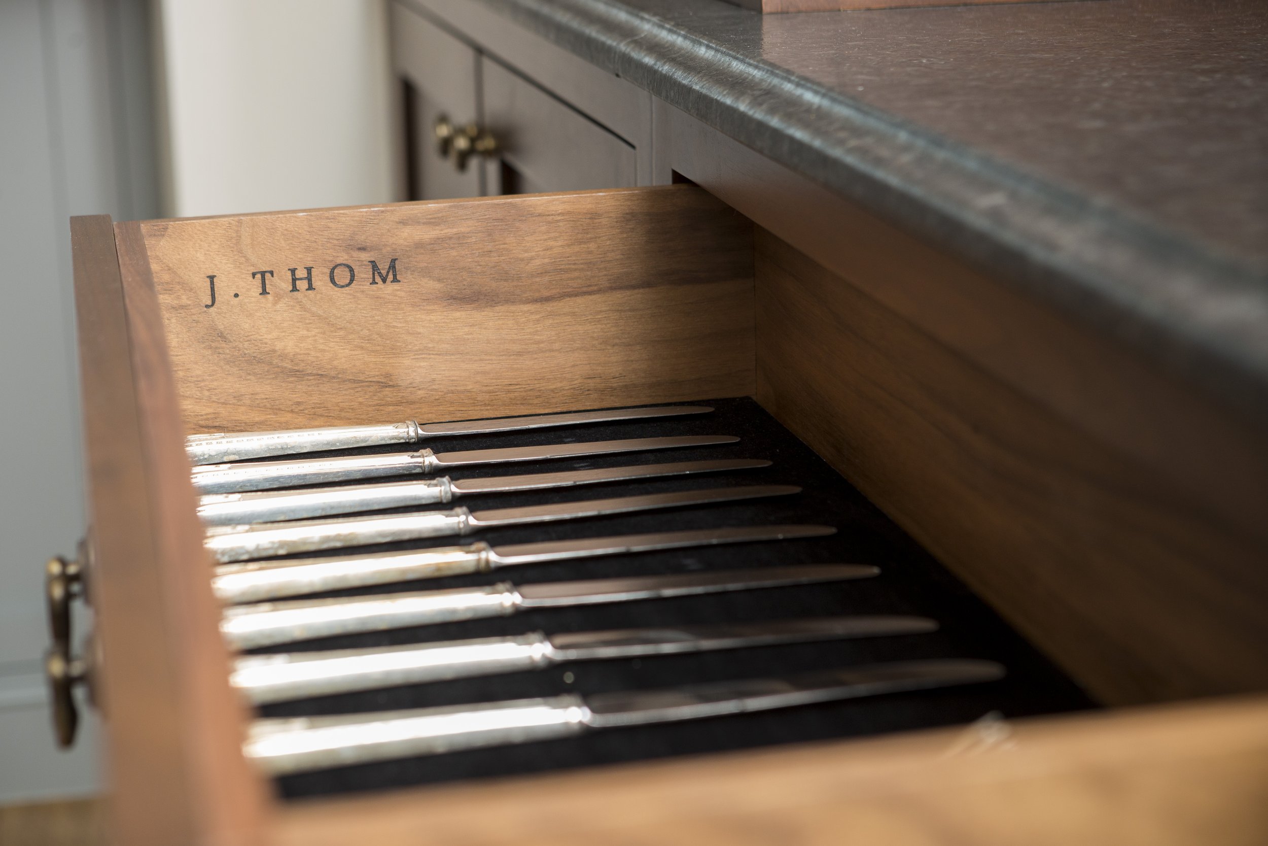 Custom cabinetry knife drawer with logo